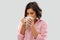 Young woman in pajama drinking coffee from mug