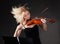 Young woman passionately playing violin