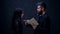 Young woman with pastor. Priest and prayer woman in the kneels. Girl is praying preaching priest with a prayer book