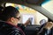 Young woman paying toll on highway at the tollbooth