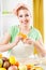 Young woman peeling oranges.