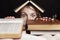 A young woman peeps out of a pile of books in horror with her eyes wide. Education and training. Black background. Close-up