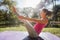 Young Woman Performing Seated Yoga Asana Boat Pose