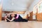 A young woman performing yoga-asanas in the hall. Eka pada shirshasana. Pavirittu Jana Shirshasana.