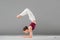 young woman performing yoga headstand with bent legs