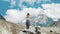 Young woman performs a basic warrior asana in yoga against the backdrop of a snowy mountain in a hike. Girl does