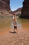 Young woman performs handstands by the Colorado River.