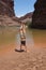 Young woman performs handstands by the Colorado River.