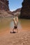 Young woman performs handstands by the Colorado River.