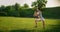 A young woman performs a static exercise on the grass for the leg and hip muscles. To rise on toes while sitting