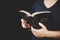 Young woman person hand holding holy bible with study at home. Adult female christian reading book in church. Girl learning