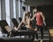 Young woman and personal trainer rest in the gym after workout