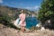 Young woman on Petani beach Kefalonia, admiring highly excited picturesque panorama of emerald blue bay of Mediterranean