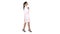 Young woman pharmacist in white gown coat uniform walking on whi