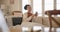 Young woman, phone and relax on sofa, thinking and blanket in home living room for texting, web chat or blog. Girl