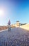 Young woman photographer beams morning sun bridge Ponto Pietra castel Vecchio river Adige Italy Verona