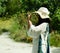 Young woman photographer taking photo, summer day