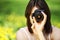 Young woman photographing in summer park