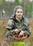 Young woman pick cranberry on a bog.