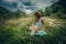 Young woman pick herbs and flowers on clean wild mountain meadow