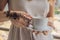 Young woman with a picture on the hand of henna - mehendi drinks coffee in the morning on the balcony overlooking the big city and