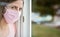 Young woman in pink cotton face virus mask standing behind window glass pane, touching it with hand, looking sad. Quarantine or