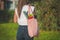 Young woman with pink eco reusable textile grocery bag with fresh bio vegetables
