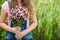 Young woman with pink flowers as gift, with copy space