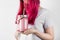 Young woman with pink hair drinks smoothies from berries and fruits. Concept meals to go