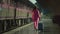 A young woman in a pink suit with a suitcase missed her train