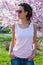 Young woman in pink tank top with dreadlocks hairstyle and sunglasses outdoor spring day