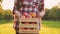 Young woman in a plaid shirt holds in her hands a wooden box