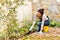 Young woman planting backyard flowerbed autumn