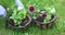 A young woman plants flowers in hanging pots. Gardening in the spring on the plot