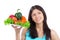 Young woman with plate of fresh healthy vegetables