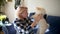 Young woman play with 2-month old pomeranian spitz puppy. Cute fluffy small dog.