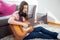 Young woman play acoustic guitar