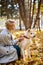 young woman play with big white pet dog akita inu in autumn forest, at sunny day.