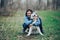 Young woman play with husky dog for a walk in spring forest. laughing having fun, happy with pet