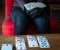 Young woman playing  cards alone at home wearing medical gloves,solitare ,while confined at home