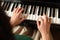 Young woman playing piano, above view. Music lesson