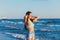 Young woman playing in the sea.woman enjoying in sea water .Cheerful young woman having fun on the summer beach