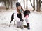 Young woman playing snow winter outdoors hugging cute adopted blind setter dog. Kindness and humanity concept.
