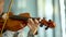 Young woman playing the violin. Hand of a female violinist on the fingerboard of a violin. Close up view