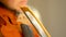 Young woman playing the violin. Hands of musician, close up view. Front view