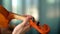 Young woman playing the violin. Hands of musician, close up view. Front view