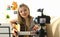 Young woman plays acoustic guitar and records video clips for social networks