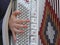 Young woman plays the ancient accordion keyboard