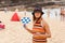 Young woman plays beach tennis on sunny day