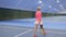 Young woman plays tennis at the indoors court